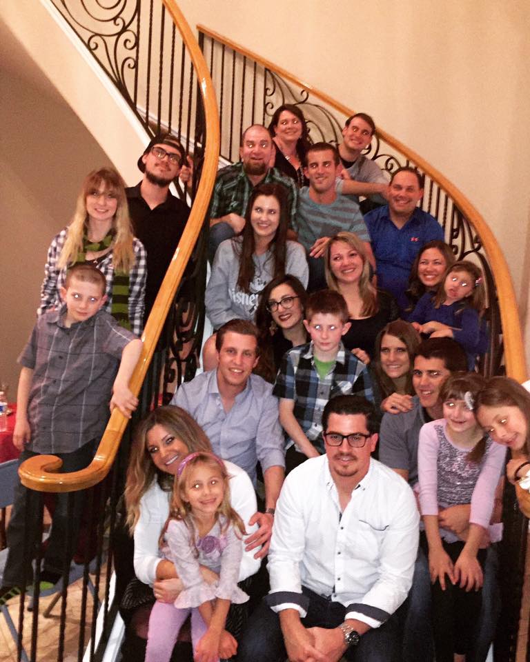 Large family group gathered on a staircase at home