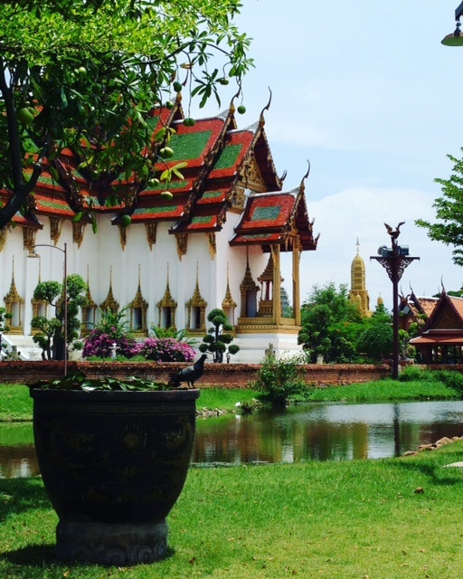 Traditional Thai temple with garden and water feature