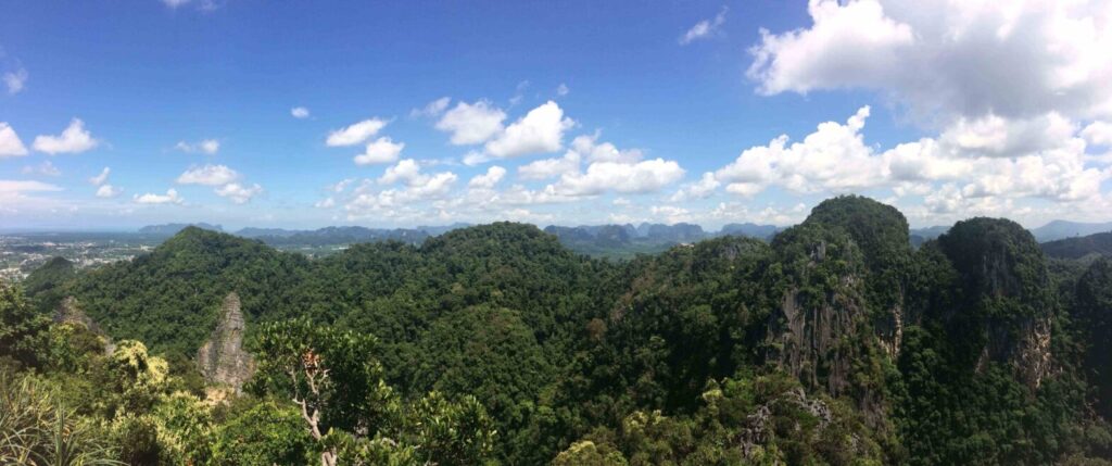 Mountain landscape in Thailand with lush green hills and blue sky