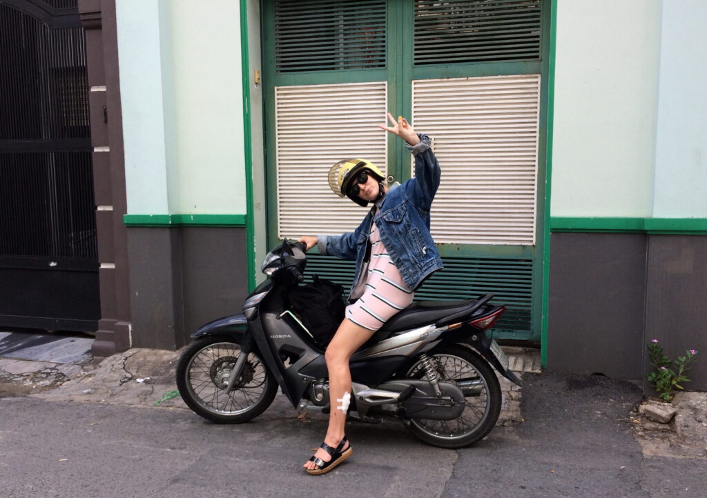 Woman posing on motorbike in Vietnam street