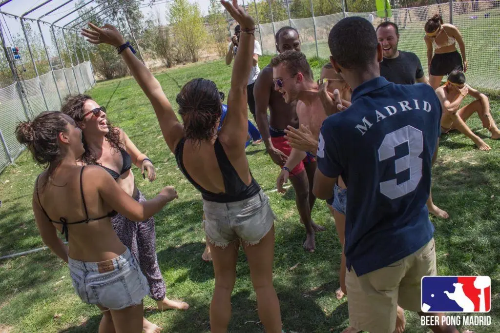 Group of friends socialising outdoors in Spain during a community event