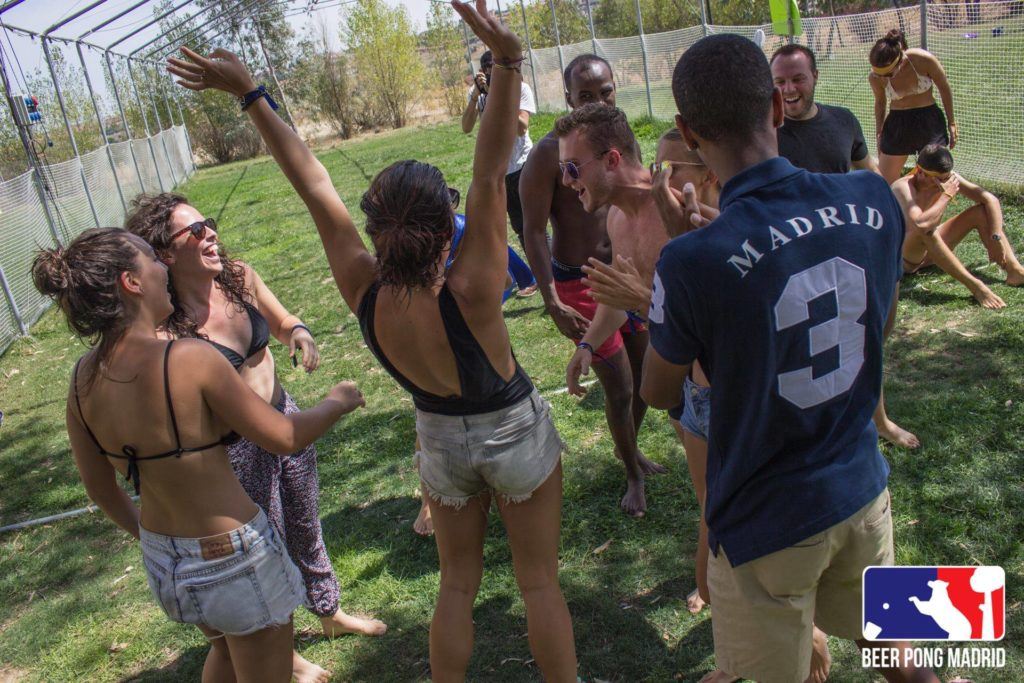 Group of friends celebrating at an outdoor pool party in Madrid
