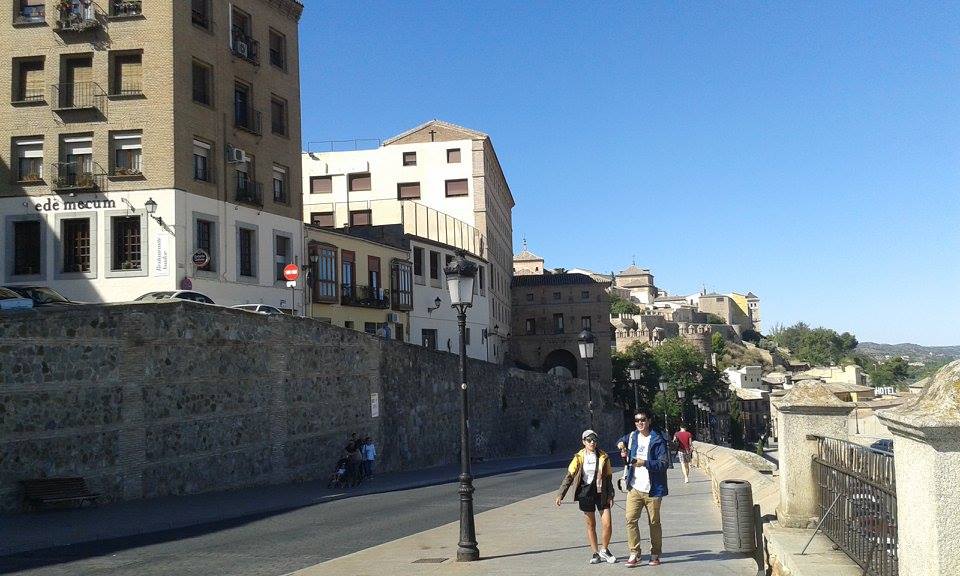 Historic street view in Toledo Spain with stone buildings and pedestrians
