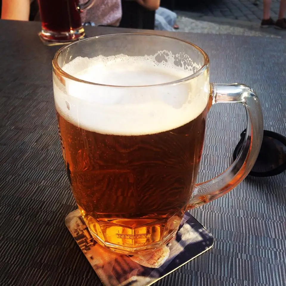 Glass of beer on outdoor table in Prague