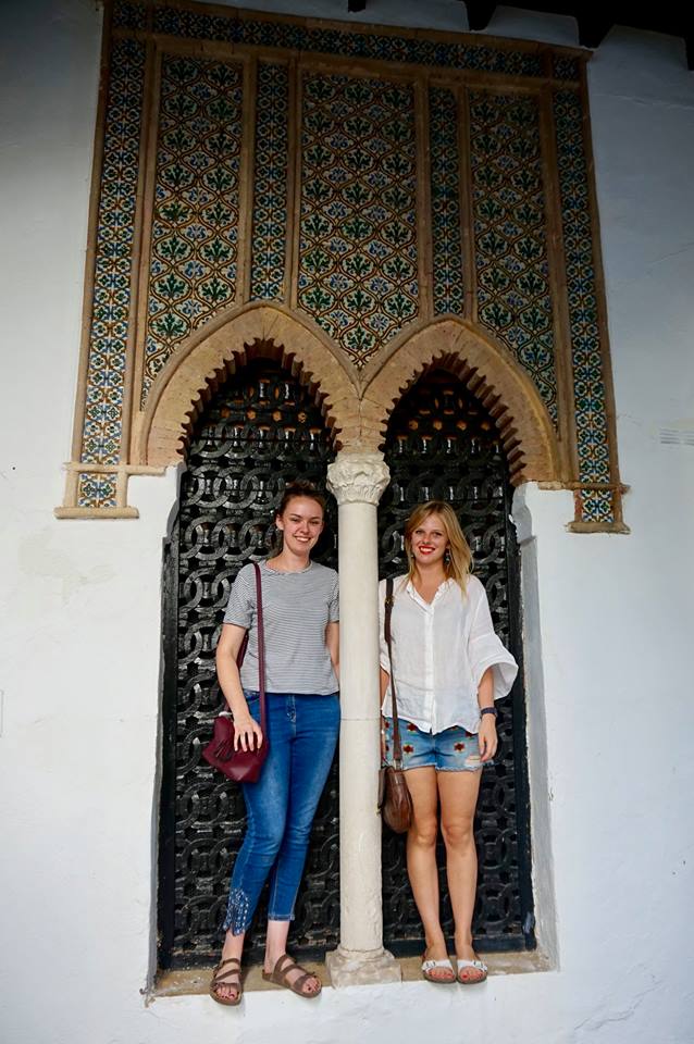 Two women standing in decorative Moorish archway in Cordoba Spain