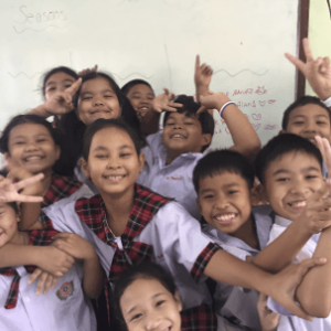 Schoolchildren smiling in a classroom in Thailand