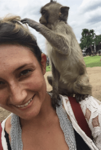 Woman taking a selfie with a monkey in Thailand