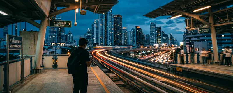 Bangkok skyline and BTS Skytrain at blue hour